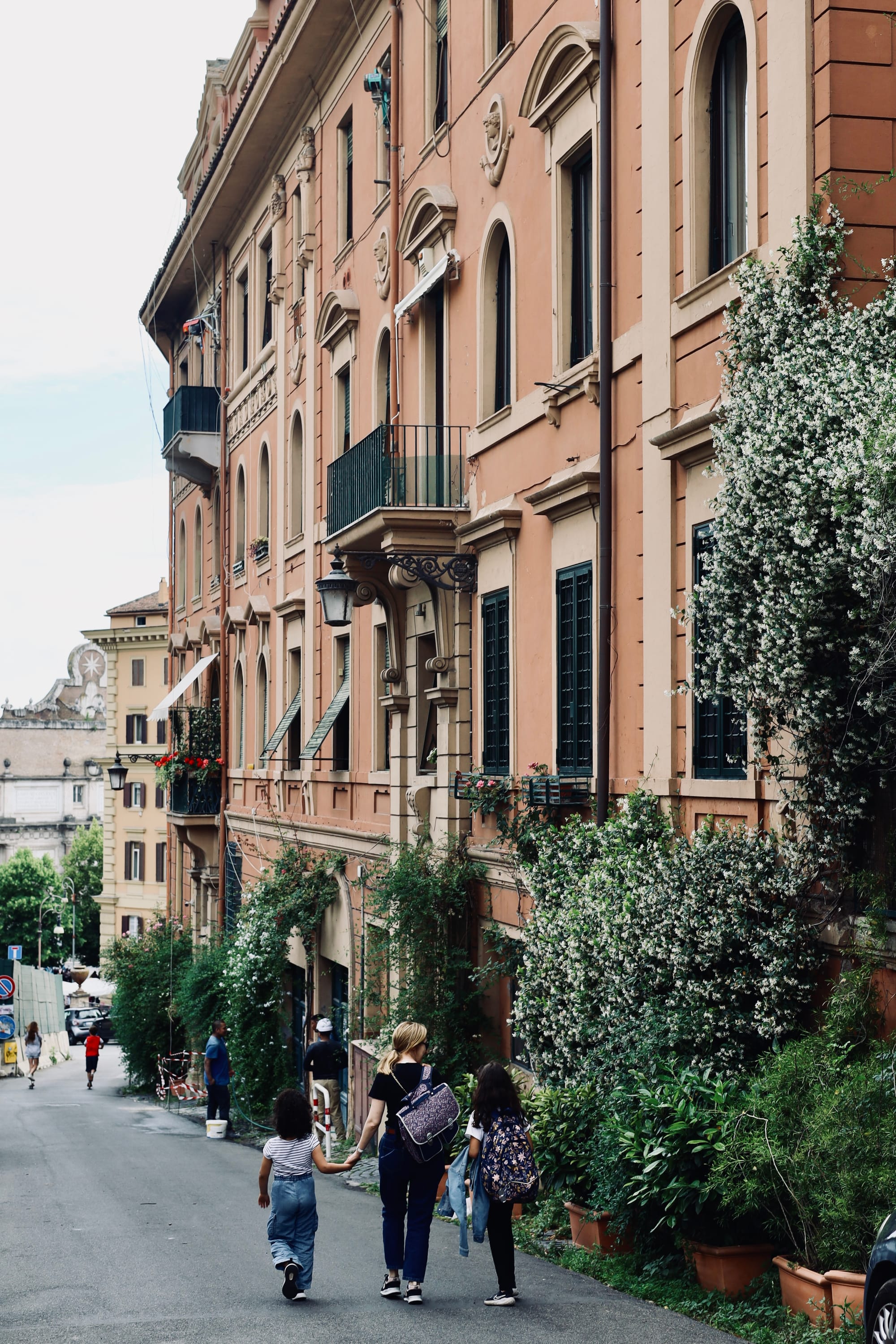 A family walking home from school in Rome.